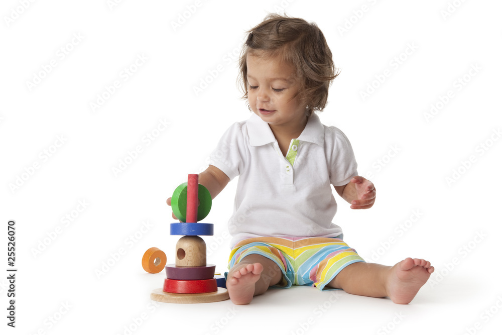 Toddler girl playing with colored bricks Toddler girl playing with colored bricks