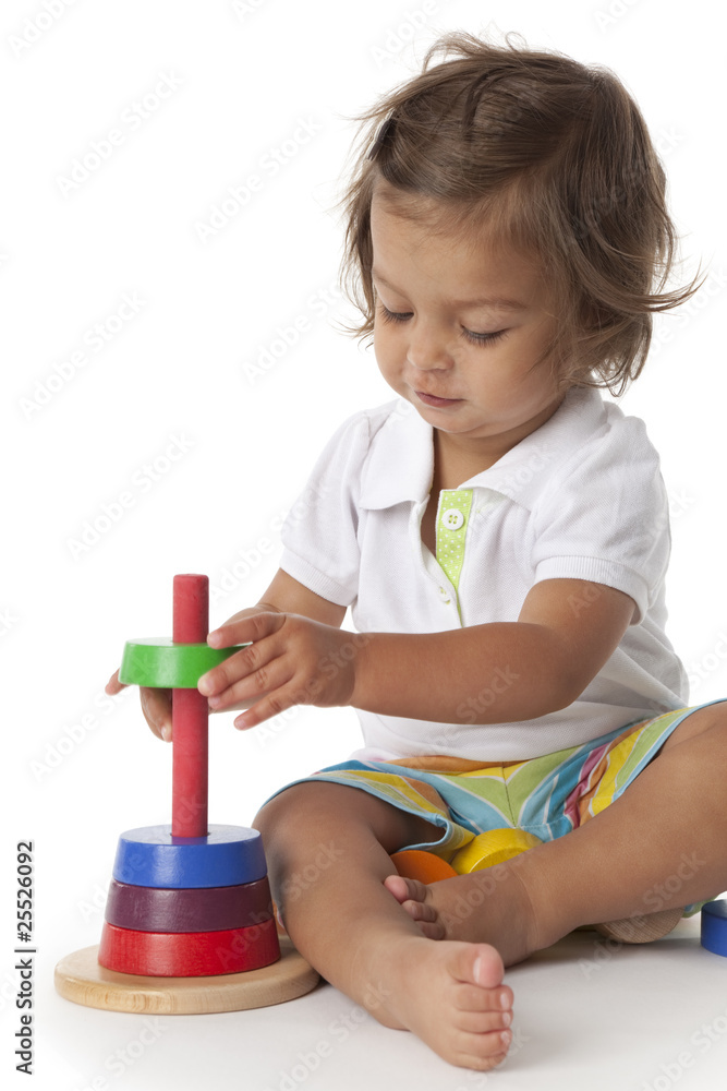 Toddler girl playing with colored bricks Toddler girl playing with colored bricks
