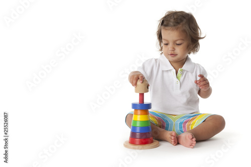 Toddler girl playing with colored bricks