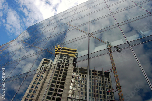 Reflection of building site on glass facade