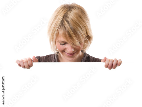 young smiling woman looking a white board under