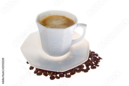 A cup of coffee with coffee grains