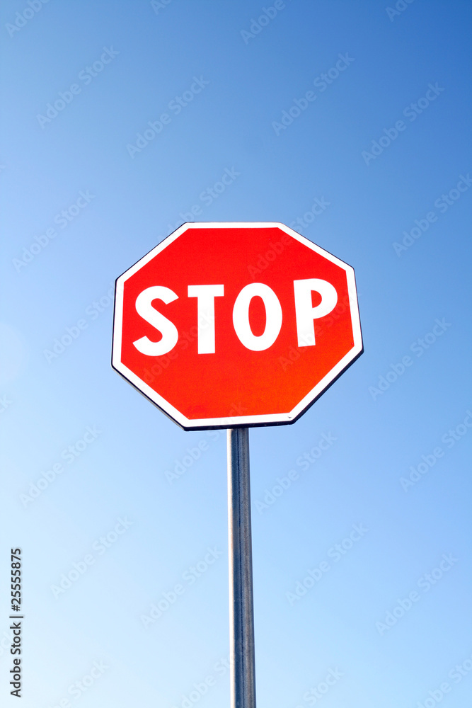 Stop sign for traffic against blue sky