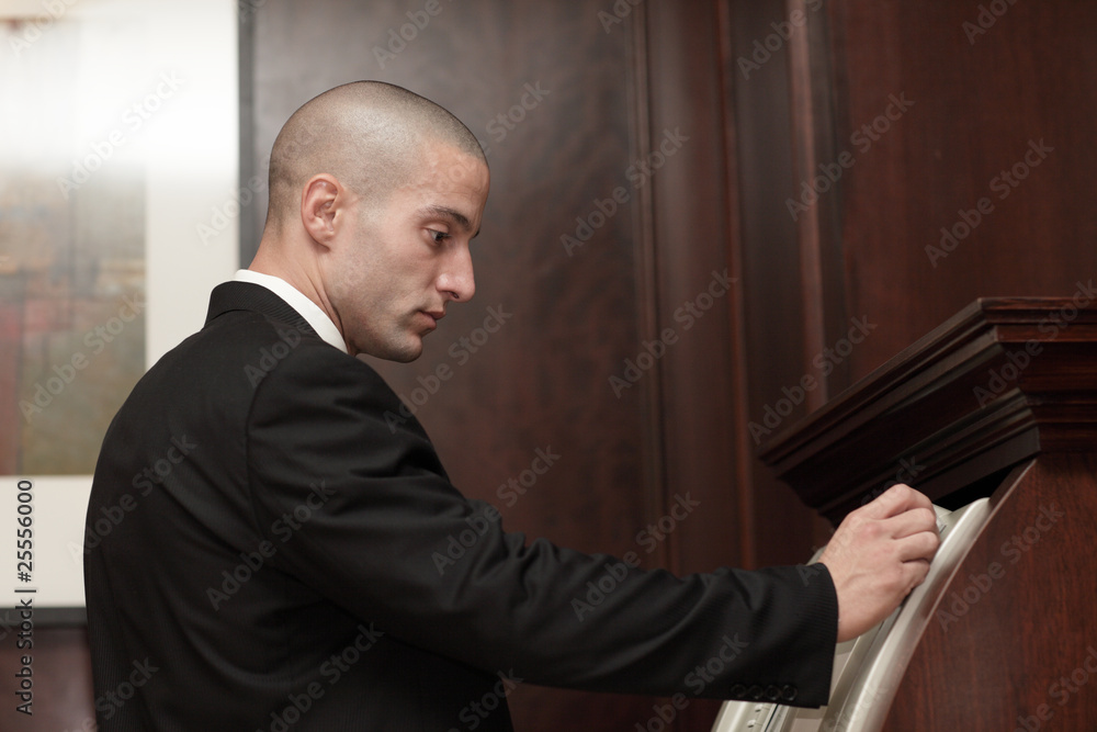 Businessman swiping a credit card in an atm Businessman swiping a credit card in an atm