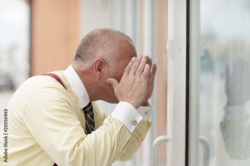 Man looking through the glass Man looking through the glass