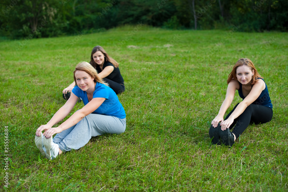 Three cute girls work out in nature