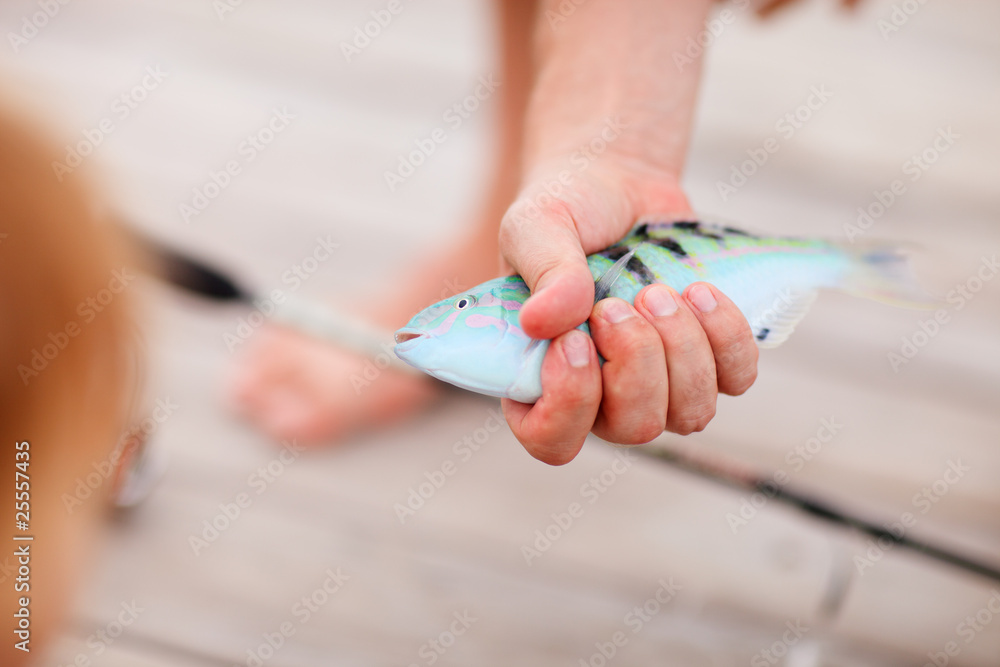 Fisherman holding fish