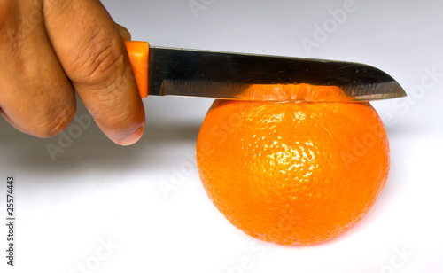 chopping orange on white background