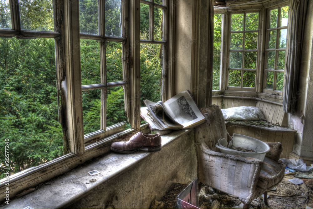 HDR photo of shoes and book in window of old derelict house