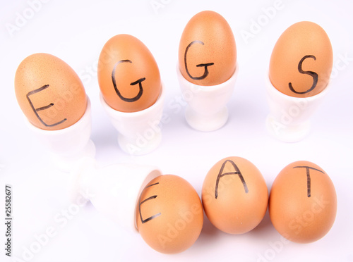 Eggs with an inscription EAT EGGS in egg holders