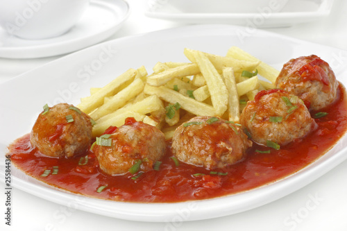 Meatballs in tomato sauce with french fries