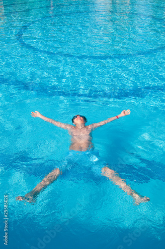 teenager swims in pool © mashe
