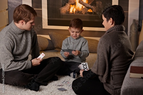 Young family playing card game