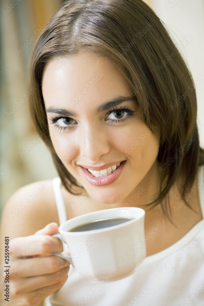 Young happy smiling woman drinking coffee, at home Young happy smiling woman drinking coffee, at home