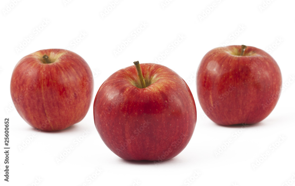 Three ripe red apples on white
