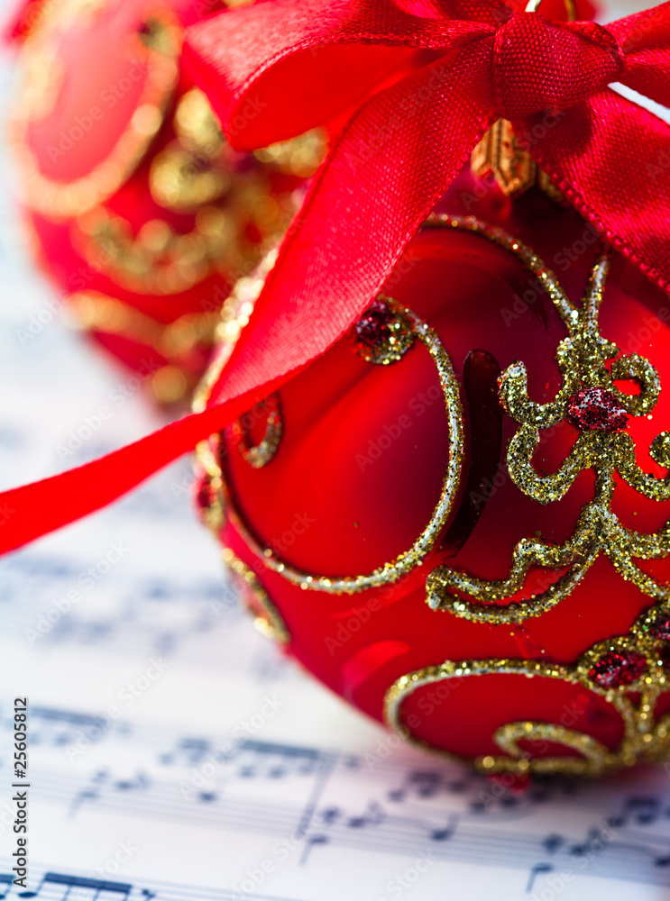 Red christmas balls over musical notation Red christmas balls over musical notation