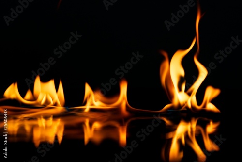 Beautiful stylish fire flames reflected in water