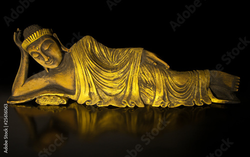 Teak wood lying buddha on black