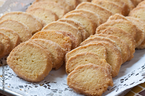 Pastry cakes with sugar on plate.