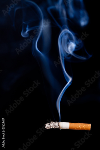 Smoking cigarette. Isolated on black.