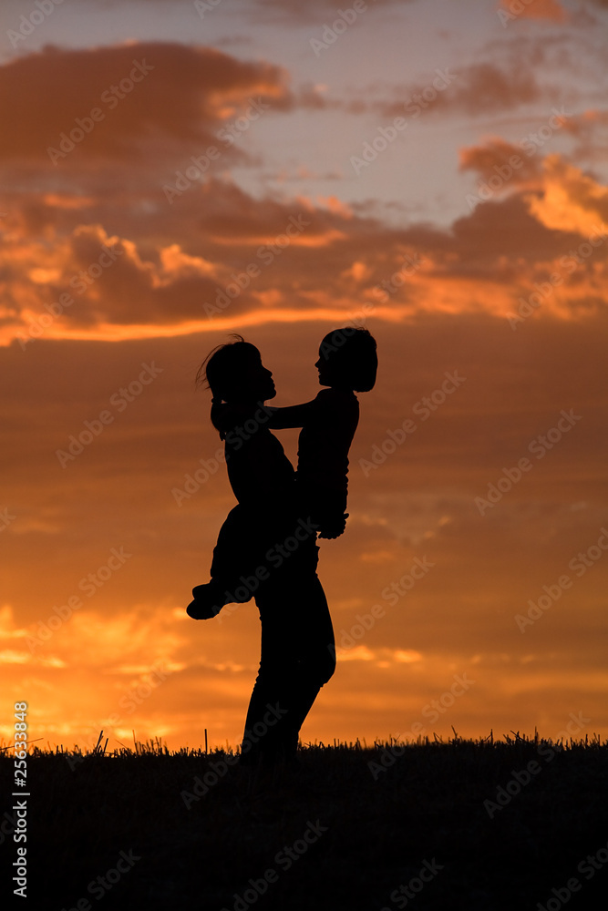 Mother and daughter at sunset.