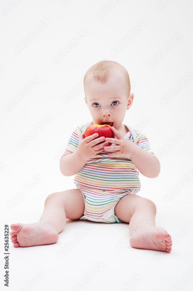boy sitting on the floor and eating apple boy sitting on the floor and eating apple