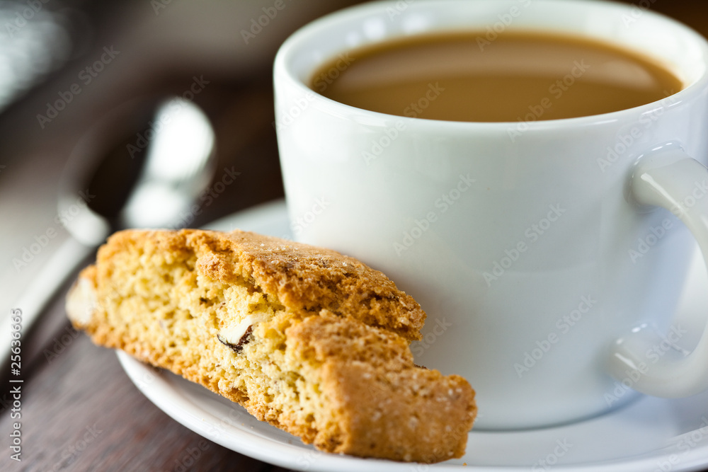 Closeup of cantuccini and a cup of coffee with milk Closeup of cantuccini and a cup of coffee with milk