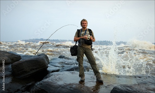 The photographer costs on the bank of raging river Congo.