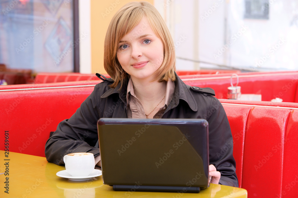 Woman at street cafe with laptop and coffee Woman at street cafe with laptop and coffee