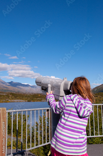 Young Girl Looking Through Telescope