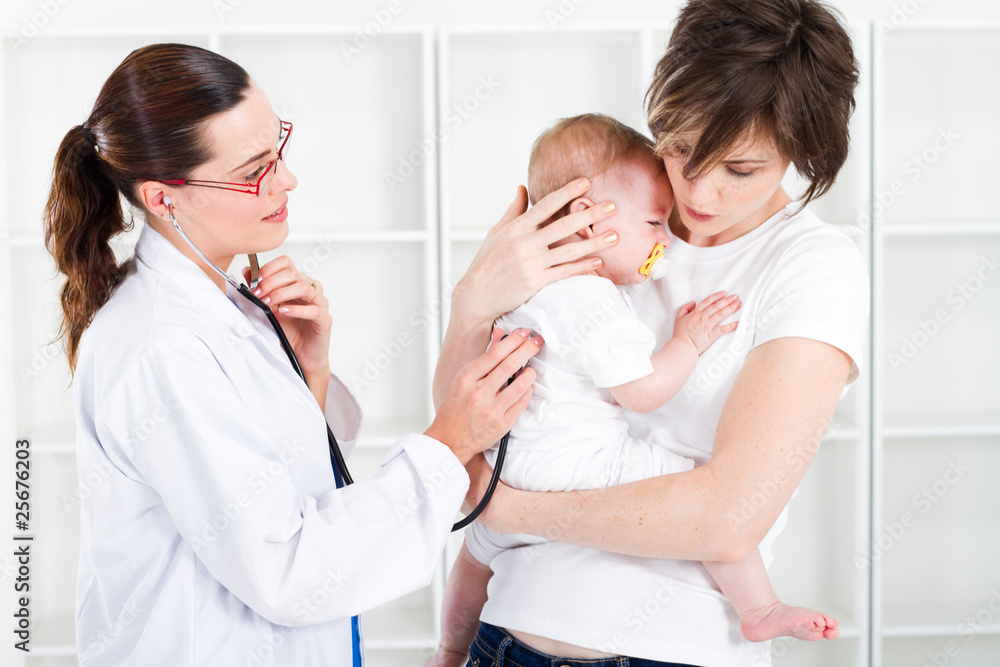 doctor checking baby in mothers arms doctor checking baby in mothers arms