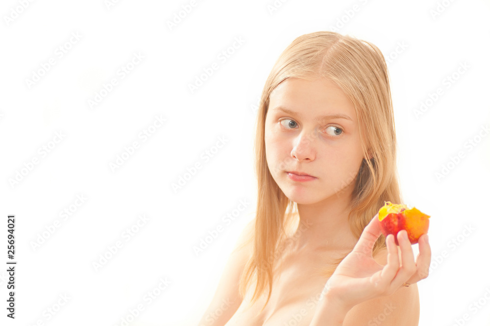 Beautiful young girl eating a peach on white Beautiful young girl eating a peach on white