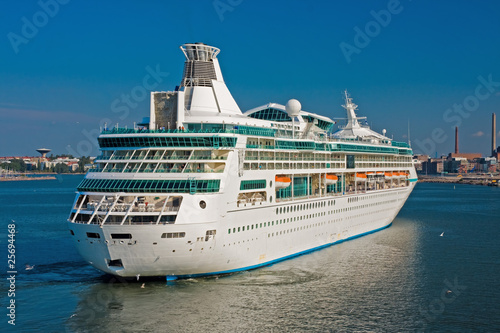 Big luxury cruise ship with Helsinky on Background