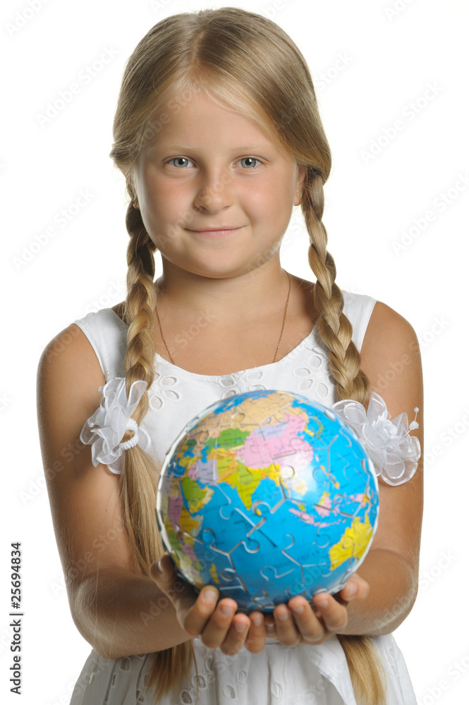 The girl holds the globe collected from puzzle in hands. Selecti The girl holds the globe collected from puzzle in hands. Selecti