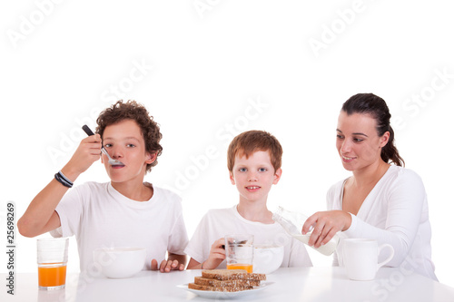 cute boys and mother taking breakfast