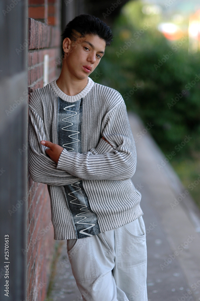 Teenage Boy leaning on a wall