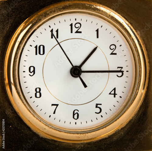 An old fashioned golden clock. Macro
