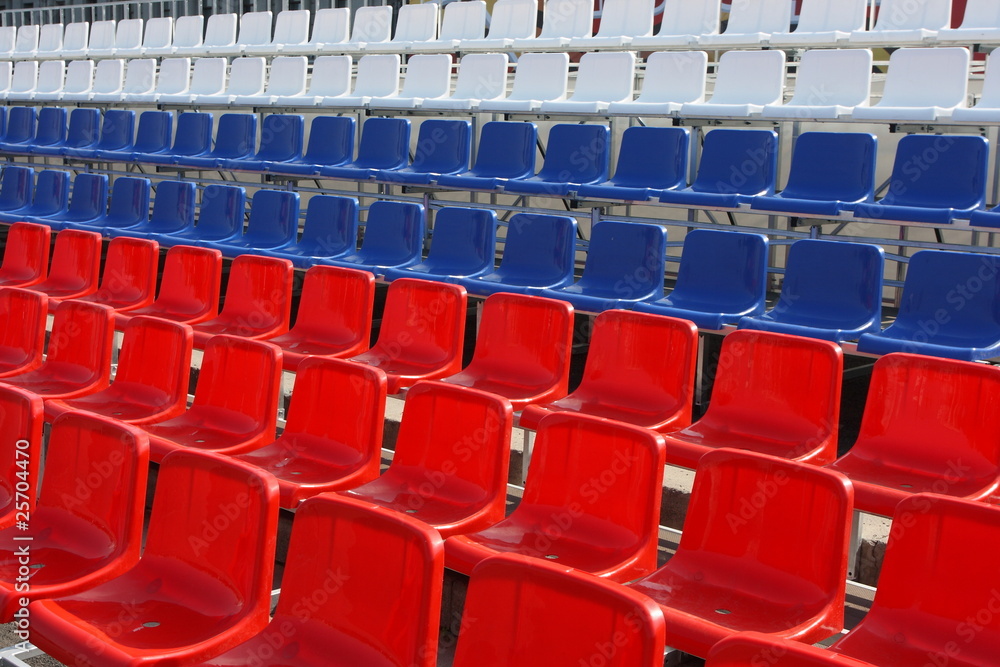 Naklejka premium Rows of red, blue and white plastic chairs