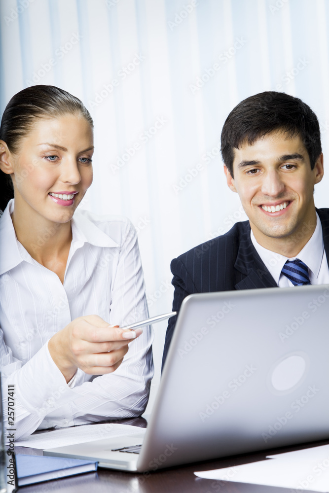 Two businesspeople working with laptop at office Two businesspeople working with laptop at office
