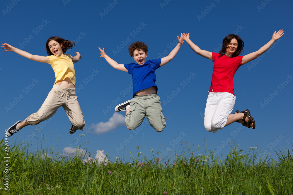 Active family - mother and kids jumping outdoor Active family - mother and kids jumping outdoor