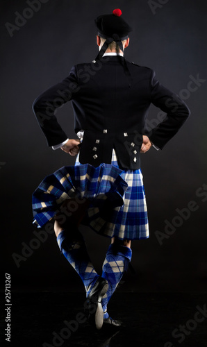 The young man dancing the Scottish dance in a kilt