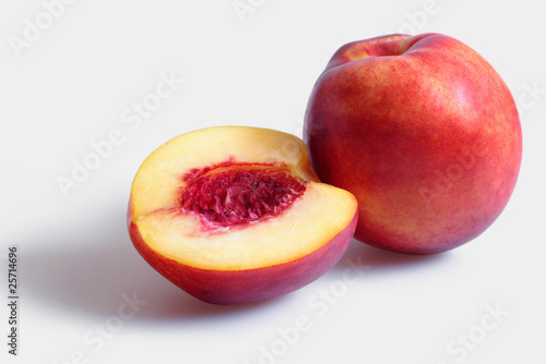 1,5 fresh peaches on white background