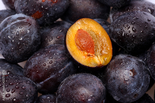 fresh plums with water pearls photo