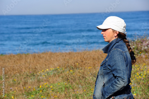 young woman in front of ocean