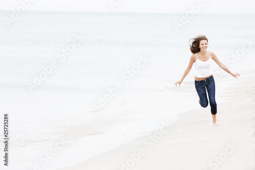 young happy girl running on beach