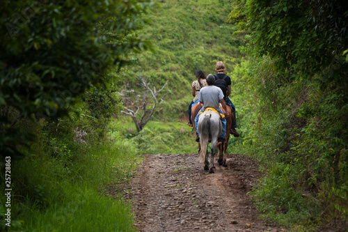 Fototapeta Tourists on horseback in Costa Rica