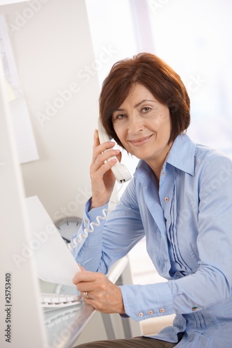 Portrait of senior office worker sitting at desk © nyul