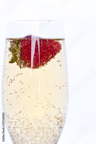 fresh strawberry in glass of champagne