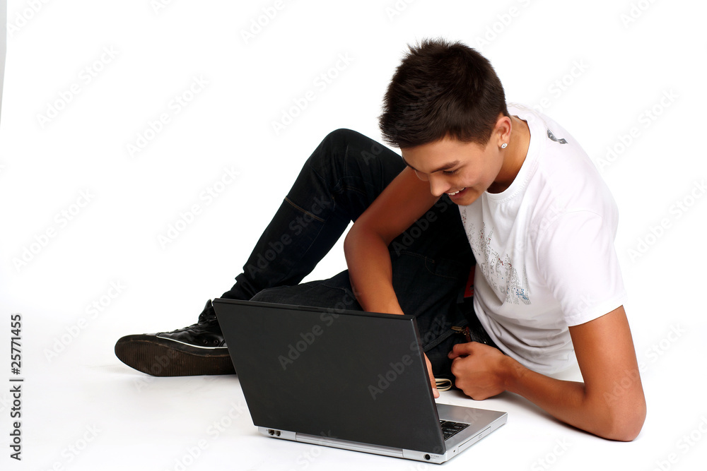 Young man sitting and using a laptop Young man sitting and using a laptop