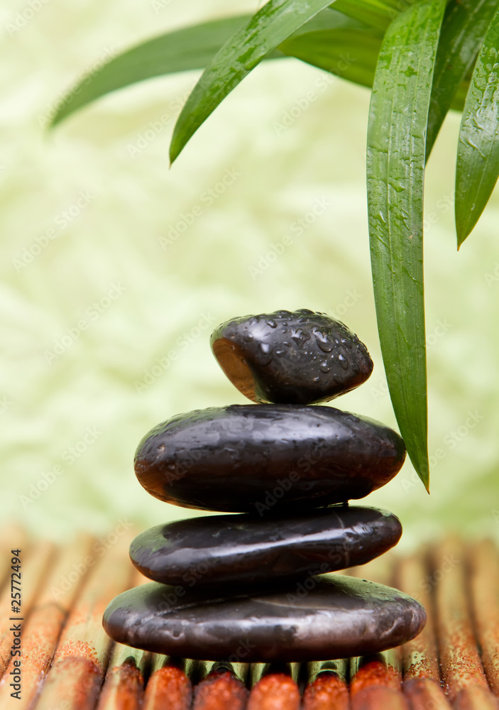 Naklejka premium Massage stones and bamboo leaves